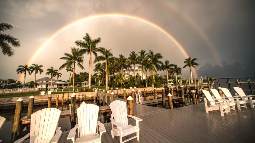 Rainbows over waterfront chairs