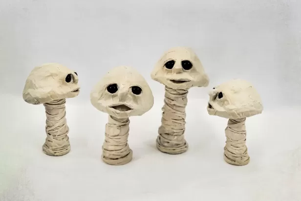 little mushroom with eyes and a mouth made from masking tape
