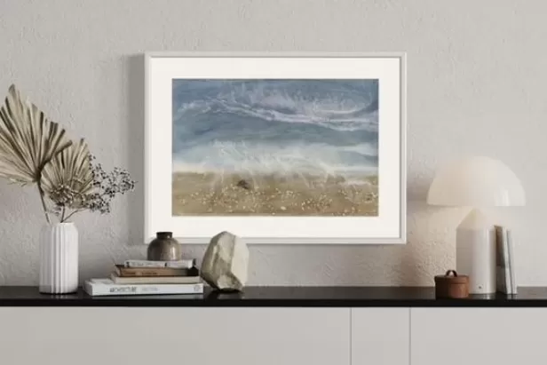 picture of a styled sideboard with a beach scene resin "painting" on the wakll