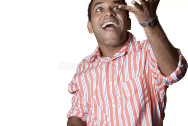 image of man in an orange and whit striped shirt juggling four hacky sacks while smiling
