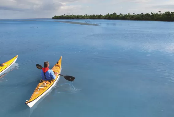 two people paddleing on boats on the blueway