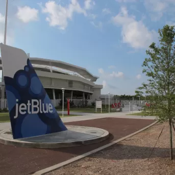 Front of Jet Blue complex boasting the tail of a jet plane