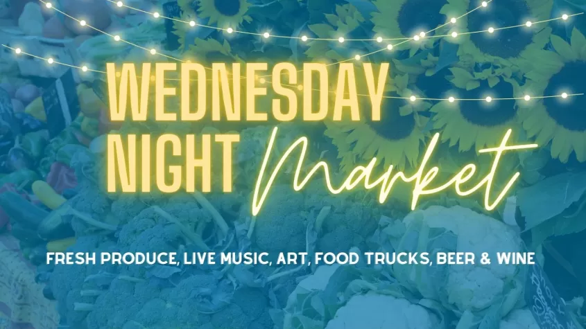 Blue background with lights and neon yellow text spelling out Wednesday Night Market