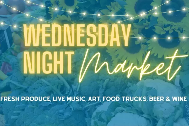 Blue background with lights and neon yellow text spelling out Wednesday Night Market
