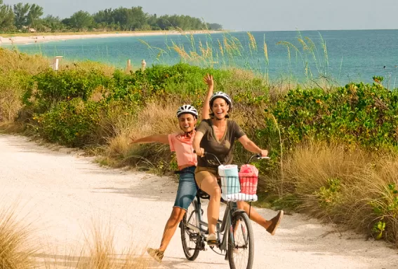 Couple cycling on a beach